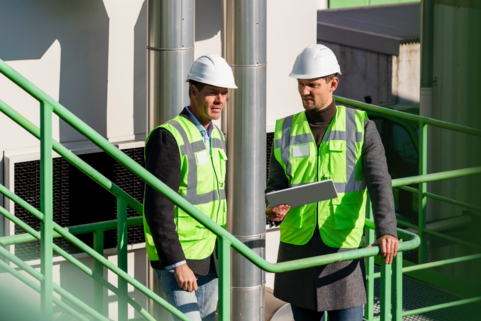 Two safety workers with white helmets
